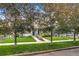 A charming home is enhanced by a lush front lawn and mature shade trees at 3937 Osceola St, Denver, CO 80212