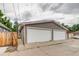 Detached two-car garage with white doors and a concrete driveway, offering ample parking space at 3937 Osceola St, Denver, CO 80212