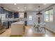 Bright kitchen with a large island, modern appliances, and an adjacent dining area at 3937 Osceola St, Denver, CO 80212
