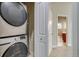 Laundry room featuring stacked washer and dryer and access to other areas of the house at 3937 Osceola St, Denver, CO 80212