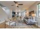 An open floor plan features hardwood floors, a modern ceiling fan, and natural light at 3937 Osceola St, Denver, CO 80212