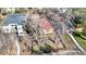 Cozy home with red roof, mature trees, and small fenced yard offering a peaceful setting at 2572 S Vine St, Denver, CO 80210