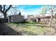 Backyard with a grass lawn, trees, and a shed, perfect for outdoor activities at 2572 S Vine St, Denver, CO 80210
