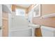 Bathroom featuring a tub, pedestal sink, and a medicine cabinet at 2572 S Vine St, Denver, CO 80210