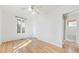 Bright bedroom with hardwood floors, ample natural light, and an adjacent bathroom at 2572 S Vine St, Denver, CO 80210