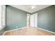 Bedroom with hardwood floors and green colored walls with a white ceiling fan at 2572 S Vine St, Denver, CO 80210