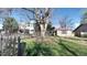 Quaint home nestled in a lush, green front yard with a vintage picket fence adding character and charm at 2572 S Vine St, Denver, CO 80210
