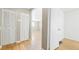 Bright hallway with hardwood floors leading into a spacious room at 2572 S Vine St, Denver, CO 80210