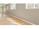 Bright living room with hardwood floors, large windows and a ceiling fan offers natural light and comfort at 2572 S Vine St, Denver, CO 80210