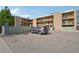 This apartment building features stone accents, multiple stories, balconies, and a parking area for tenants at 250 N Pearl St # 310, Denver, CO 80203