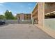 Apartment building features stone accents, balconies, parking and a gated entrance with mature shade trees at 250 N Pearl St # 310, Denver, CO 80203