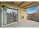 This balcony features a sliding glass door, an outdoor light, and a hanging flower basket with bright yellow flowers at 250 N Pearl St # 310, Denver, CO 80203
