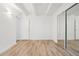 Bedroom featuring wood-look floors and sliding mirrored closet doors at 250 N Pearl St # 310, Denver, CO 80203