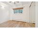 Bedroom featuring wood-look floors, brick accent wall and large window at 250 N Pearl St # 310, Denver, CO 80203