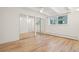 Bedroom showing wood-look floors, window and mirrored closet at 250 N Pearl St # 310, Denver, CO 80203