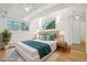 Comfortable bedroom featuring a large window, hardwood floors, and stylish decor at 250 N Pearl St # 310, Denver, CO 80203