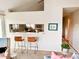 Bright living room with seating, bar, and view into kitchen space at 6899 Countryside Ln # 269, Niwot, CO 80503