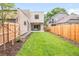 Lush backyard with newly laid sod, privacy fence, and stylish modern home design at 1466 S Gaylord St, Denver, CO 80210