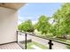 Charming balcony with modern railings and a lovely neighborhood street view with greenery at 1466 S Gaylord St, Denver, CO 80210