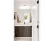 Modern bathroom featuring a vanity with dark wood cabinets, white countertop, and bronze hardware at 1466 S Gaylord St, Denver, CO 80210