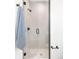 Bathroom featuring glass walk-in shower with a tile surround and black hardware at 1466 S Gaylord St, Denver, CO 80210