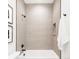 Modern bathroom features a sleek shower and bathtub with tiled walls, stylish fixtures, and a convenient recessed niche at 1466 S Gaylord St, Denver, CO 80210