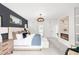 Bright bedroom featuring a fireplace, ensuite access, and balcony access through large glass doors at 1466 S Gaylord St, Denver, CO 80210