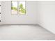 A bright bedroom with neutral carpet and a large window allowing natural light at 1466 S Gaylord St, Denver, CO 80210