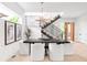 Bright dining area featuring an artistic light fixture and view of staircase, offering a modern aesthetic at 1466 S Gaylord St, Denver, CO 80210