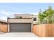 Modern home with a large garage, brick and siding, and a well-manicured yard at 1466 S Gaylord St, Denver, CO 80210