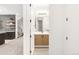Bright hallway leading to a stylish wet bar and a modern bathroom, with contemporary design elements throughout the space at 1466 S Gaylord St, Denver, CO 80210