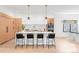 Bright, modern kitchen featuring a large island with seating, white countertops and wood cabinets at 1466 S Gaylord St, Denver, CO 80210