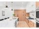 Bright and spacious kitchen with a large island, modern appliances, and light wood cabinetry at 1466 S Gaylord St, Denver, CO 80210