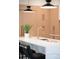 Stylish kitchen island featuring a gold faucet, quartz countertops and modern black and gold pendant lighting at 1466 S Gaylord St, Denver, CO 80210