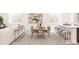 Spacious living room featuring modern table and chairs, contemporary artwork, and bright light from windows with plantation shutters at 1466 S Gaylord St, Denver, CO 80210