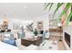 Spacious open-concept living space featuring modern decor, hardwood floors and adjacent kitchen at 1466 S Gaylord St, Denver, CO 80210