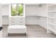 Bright walk-in closet features custom shelving, drawers and a large window for natural light at 1466 S Gaylord St, Denver, CO 80210