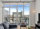 City view from balcony showcasing nearby buildings and a peek inside living room at 891 14Th St # 3411, Denver, CO 80202