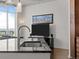 Close-up of the kitchen island with sink, faucet, granite countertops, and modern fixtures at 891 14Th St # 3411, Denver, CO 80202