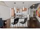 Modern kitchen with a black countertop island, stainless steel appliances, and stylish pendant lighting at 891 14Th St # 3411, Denver, CO 80202