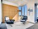 Cozy living room area featuring two black chairs, natural light and city views at 891 14Th St # 3411, Denver, CO 80202