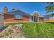 Spacious backyard with well-maintained lawn and mature trees, showing the exterior of the home at 912 S Kingston St, Aurora, CO 80012