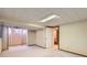 Spacious basement featuring carpet flooring, paneled walls, and access to the bathroom at 912 S Kingston St, Aurora, CO 80012
