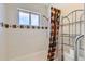Bathroom with white tile, colorful shower curtain and metal shelving at 912 S Kingston St, Aurora, CO 80012