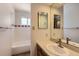 Bright bathroom features a tub-shower combo and mirrored vanity at 912 S Kingston St, Aurora, CO 80012