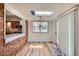 Bright dining room featuring brick wall, hardwood floors and slider to backyard at 912 S Kingston St, Aurora, CO 80012