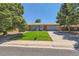 Charming single-story home with brick exterior, lush green lawn, mature trees, and a two-car garage at 912 S Kingston St, Aurora, CO 80012