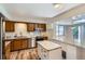 Functional kitchen featuring wood cabinets, island with granite countertop, and stainless steel appliances at 912 S Kingston St, Aurora, CO 80012