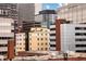 This cityscape captures a dense collection of buildings with varying heights and architectural styles in an urban setting at 1975 N Grant St # 617, Denver, CO 80203