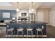Modern kitchen features stainless steel appliances, black countertop, and barstool seating at 1975 N Grant St # 617, Denver, CO 80203